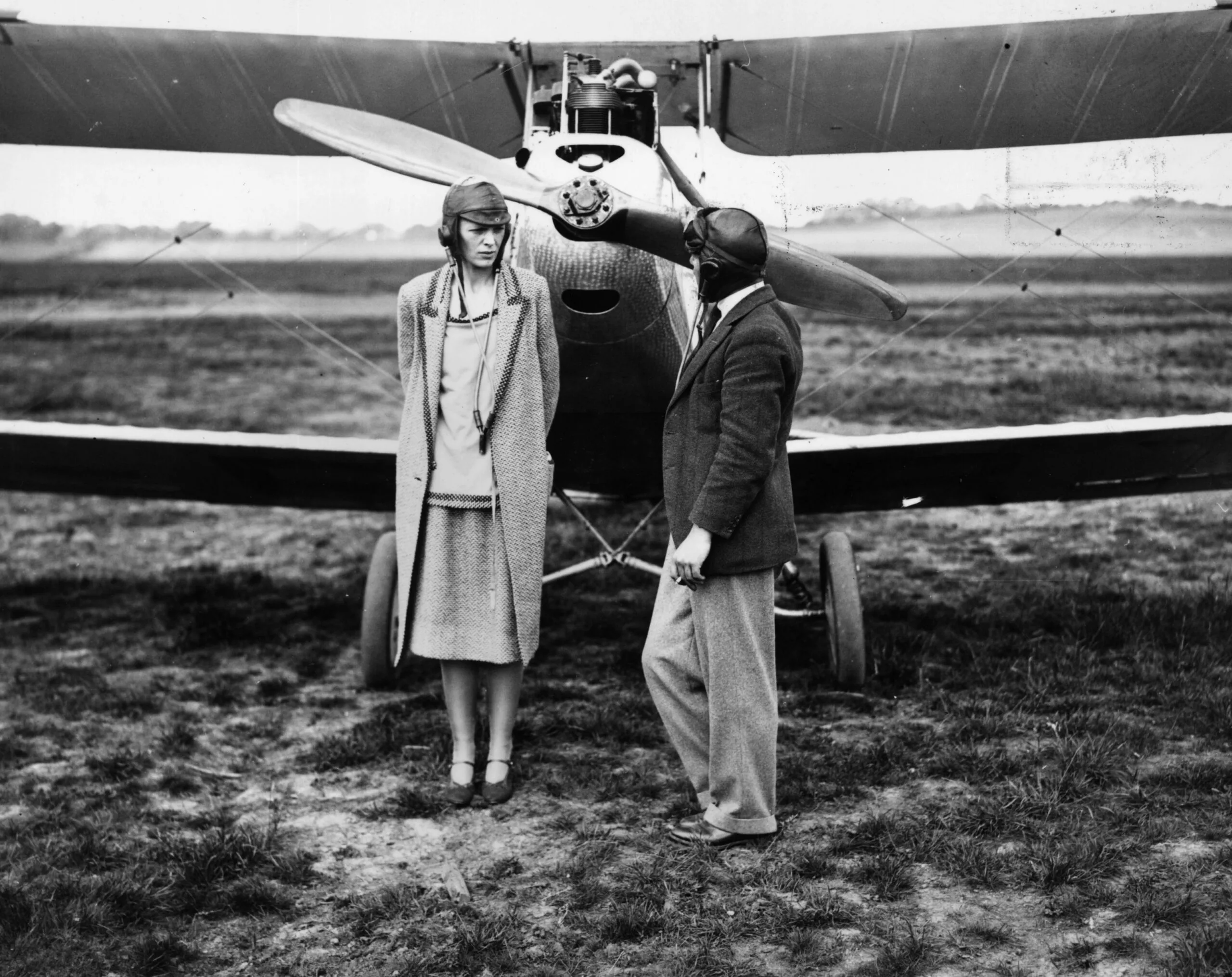 24th June 1928: American aviator Amelia Earhart (1898-1937) with her pilot Captain A H White, after their trip to Northolt in a moth aircraft. (Photo by H. F. Davis/Topical Press Agency/Getty Images)