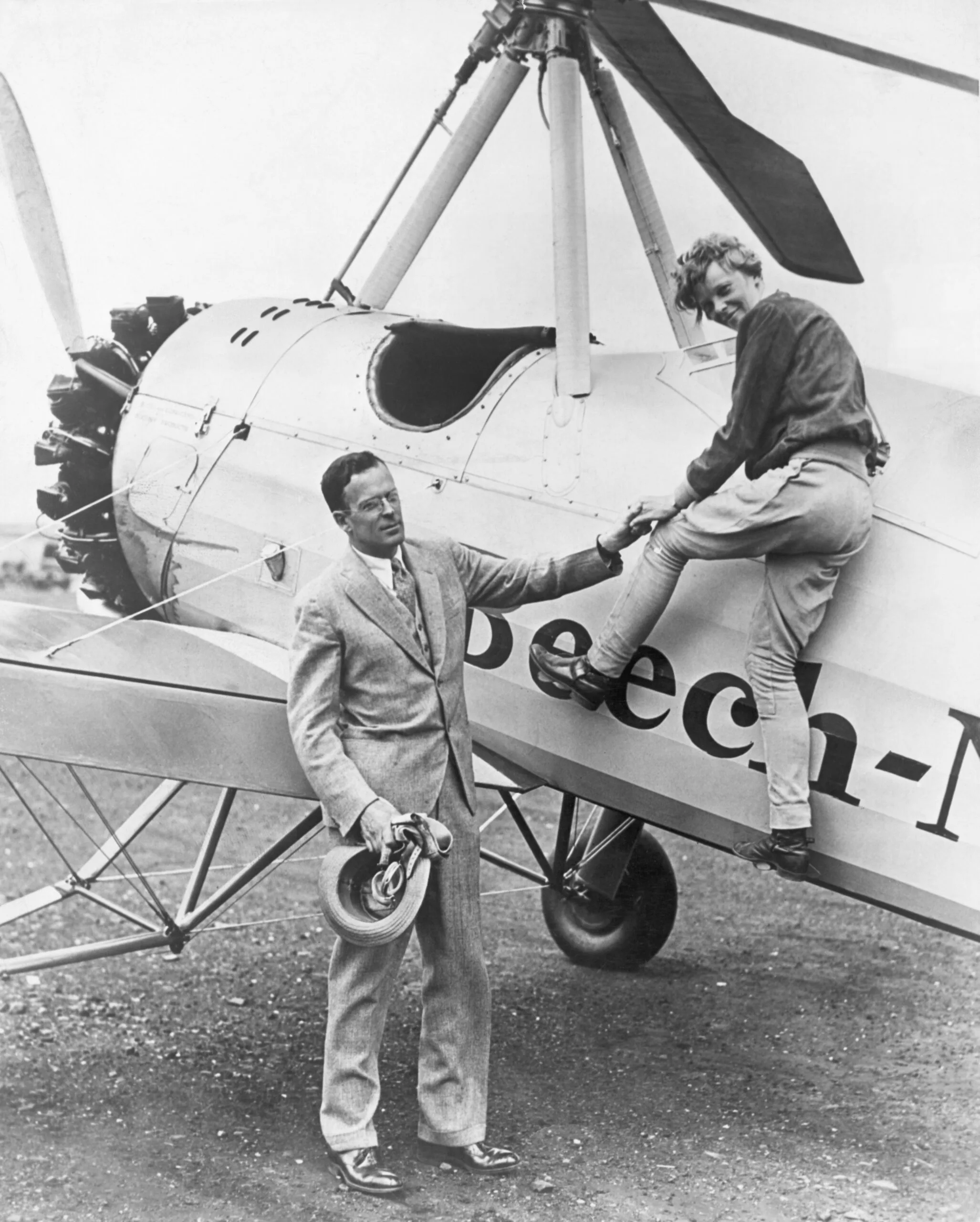 (Original Caption) 1931-Newark, NJ: Picture of Amelia Earhart (1898-1937) being assiszted from her plane by her husband, David Palmer Putnam following her arrival at Metropolitan Airport.