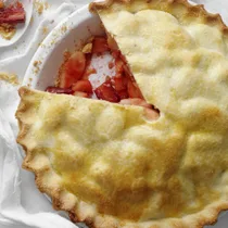 apple and rhubarb pie with a slice cut out