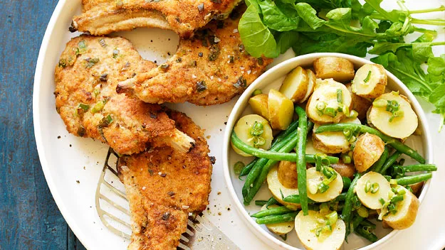 Crumbed pork cutlets with warm potato salad