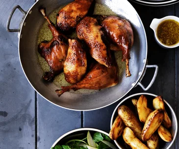 Duck confit with pan-fried kipflers and pear and watercress salad