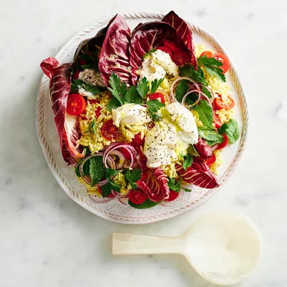 plate of orzo pasta salad with burrata and greens