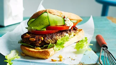 Lamb burger in a bun with salad on a plate