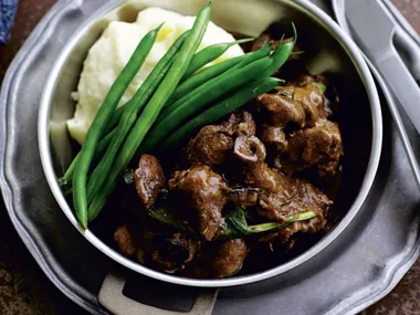 Beef and mushroom casserole with mashed potato and green beans