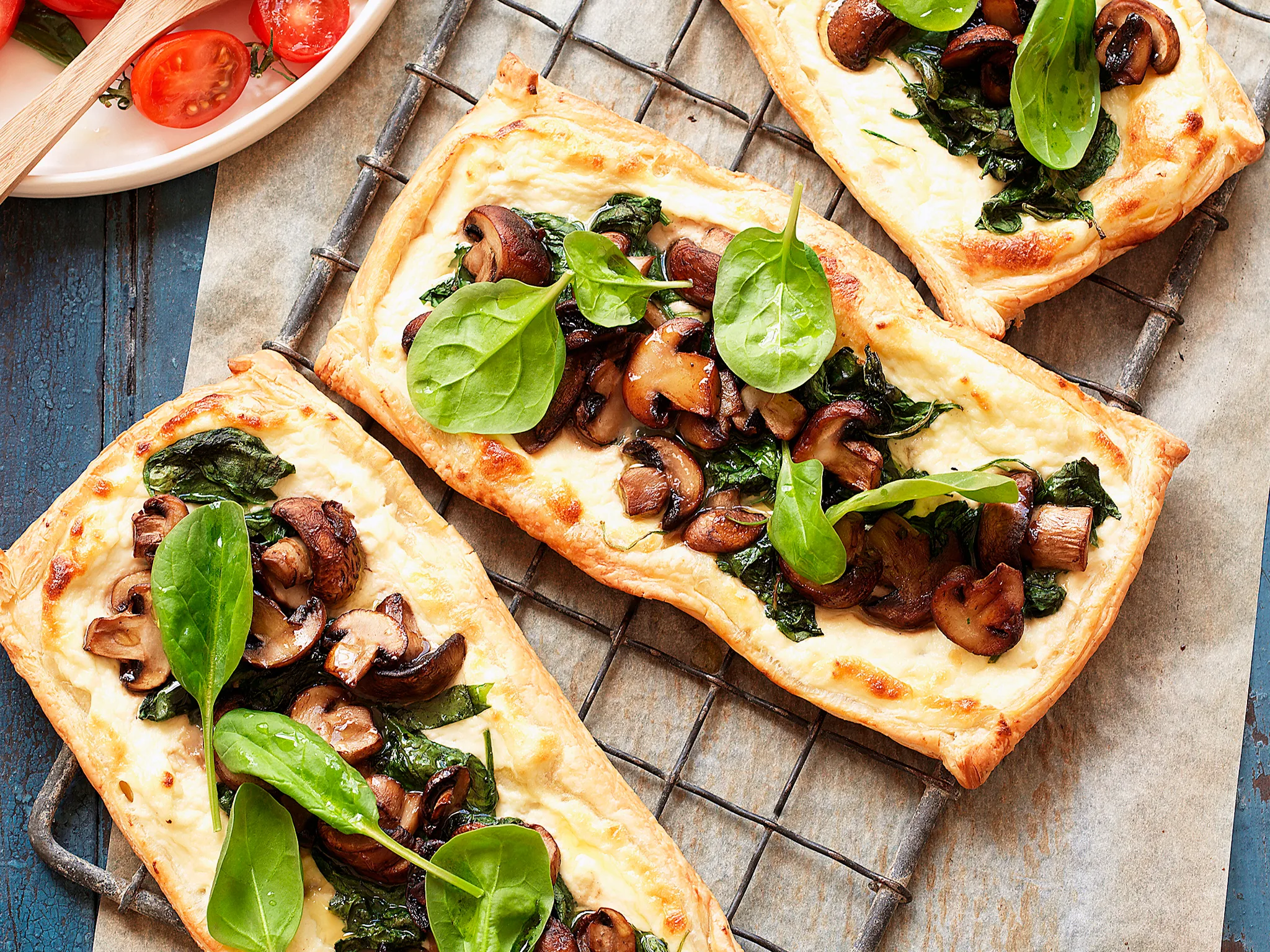 Mushroom and spinach tarts with tomato salad