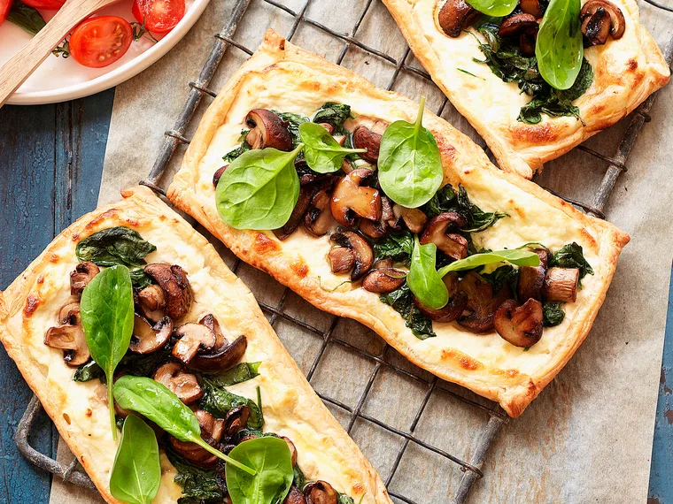 Mushroom and spinach tarts with tomato salad