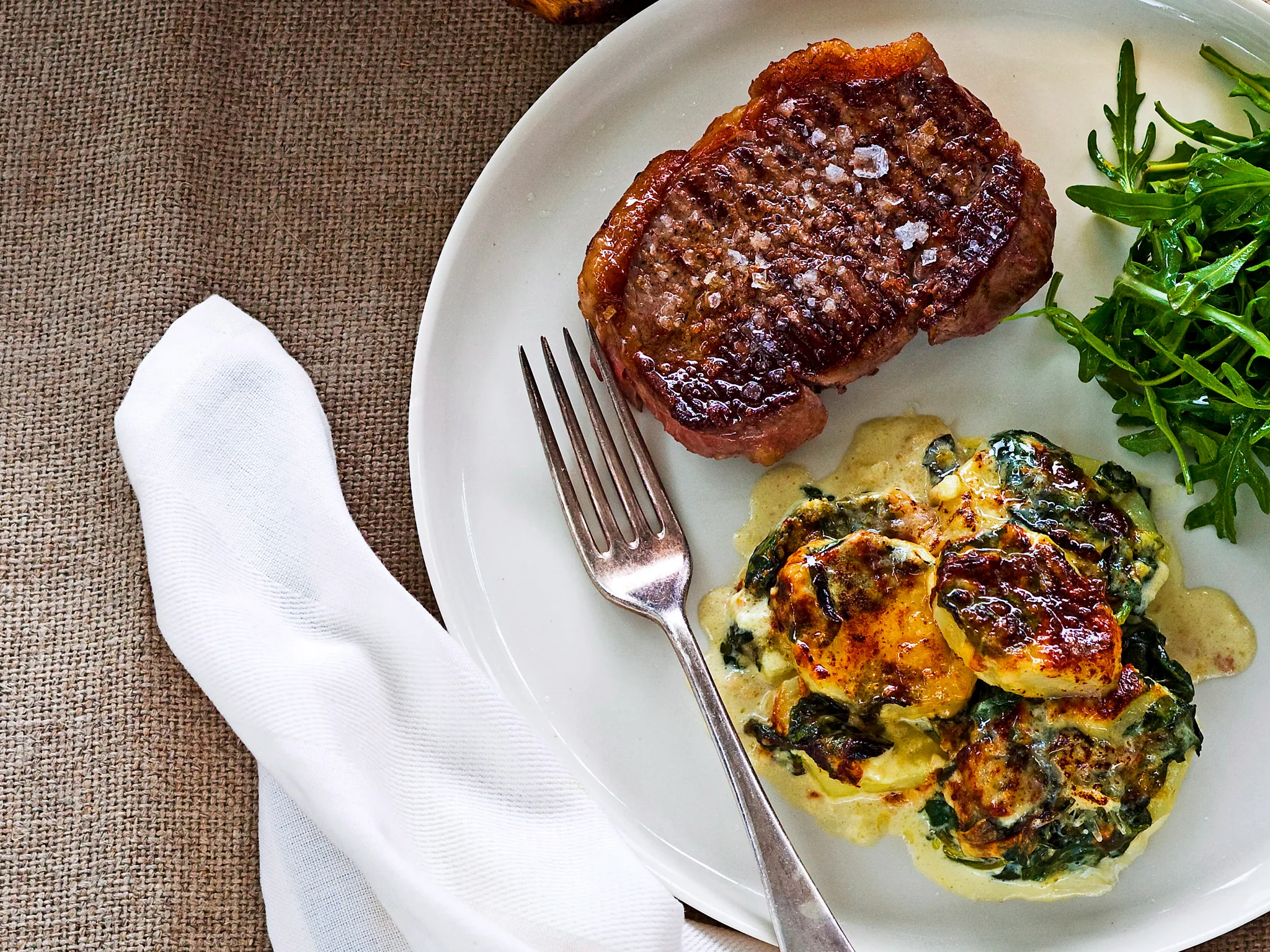 new york steak with potato and spinach dauphinoise