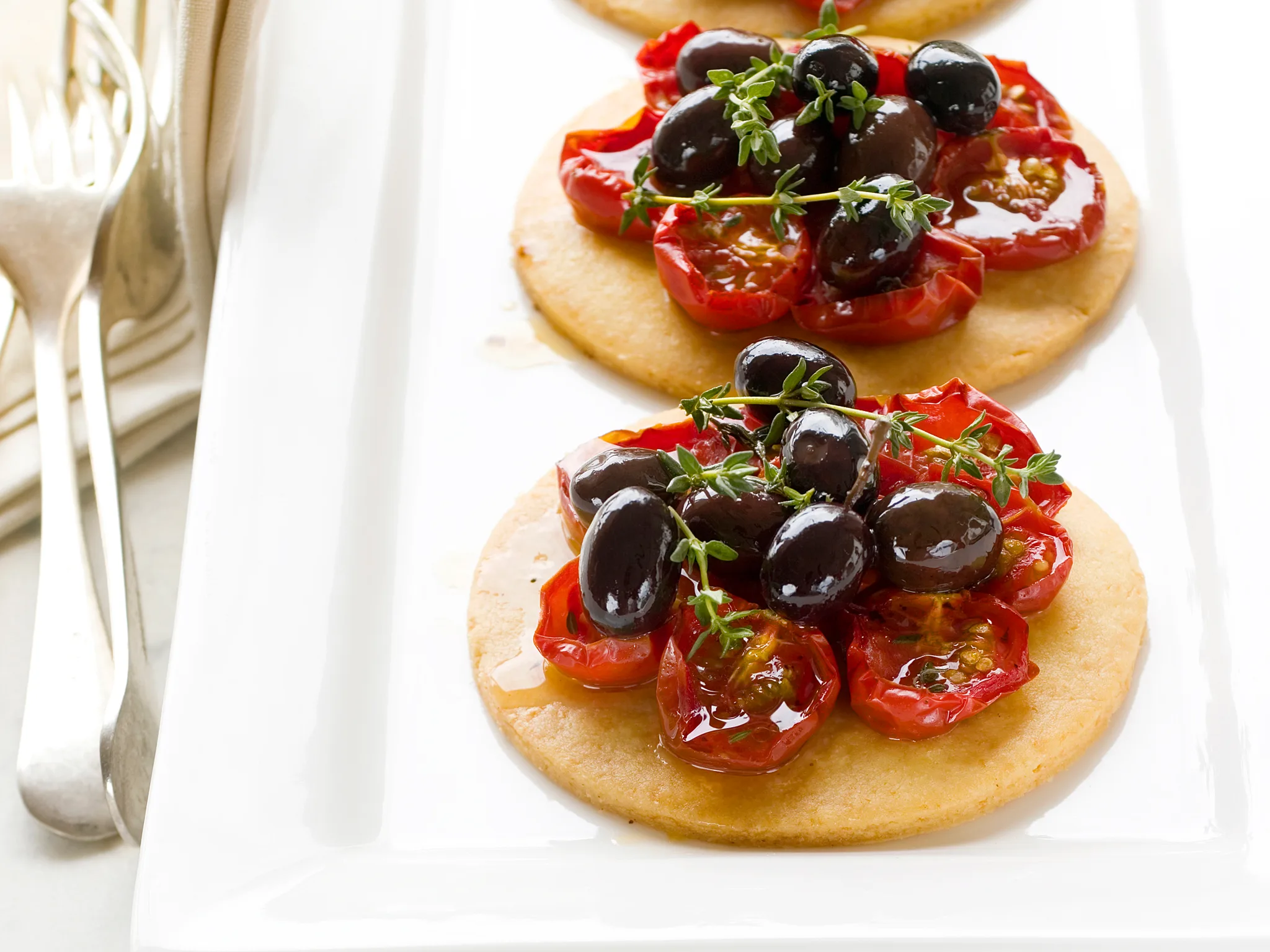 Parmesan, tomato and olive tarts