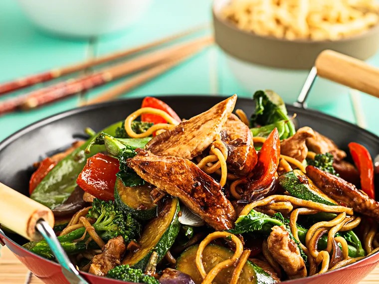 Sesame chicken and vegetable stir-fry with asian style dressing