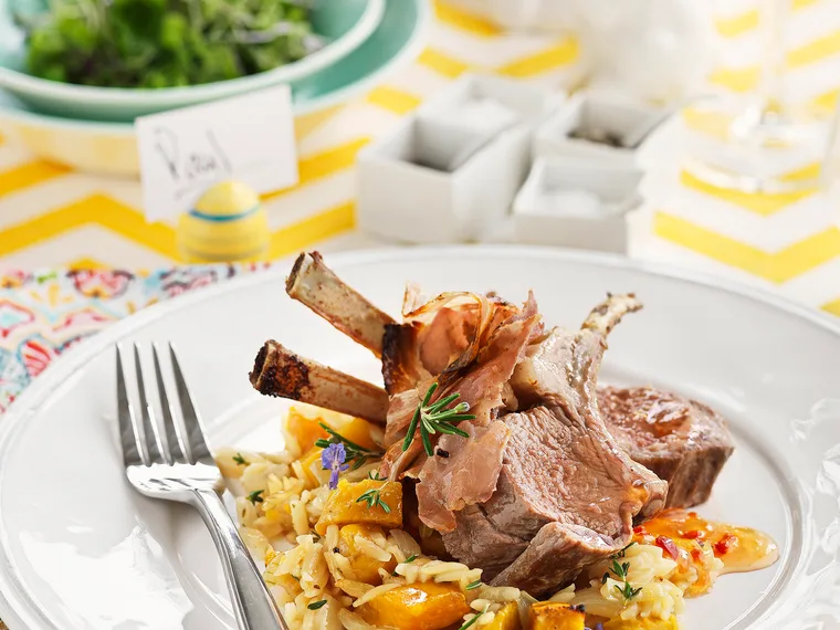 Lamb racks and pancetta with baked kumara orzo