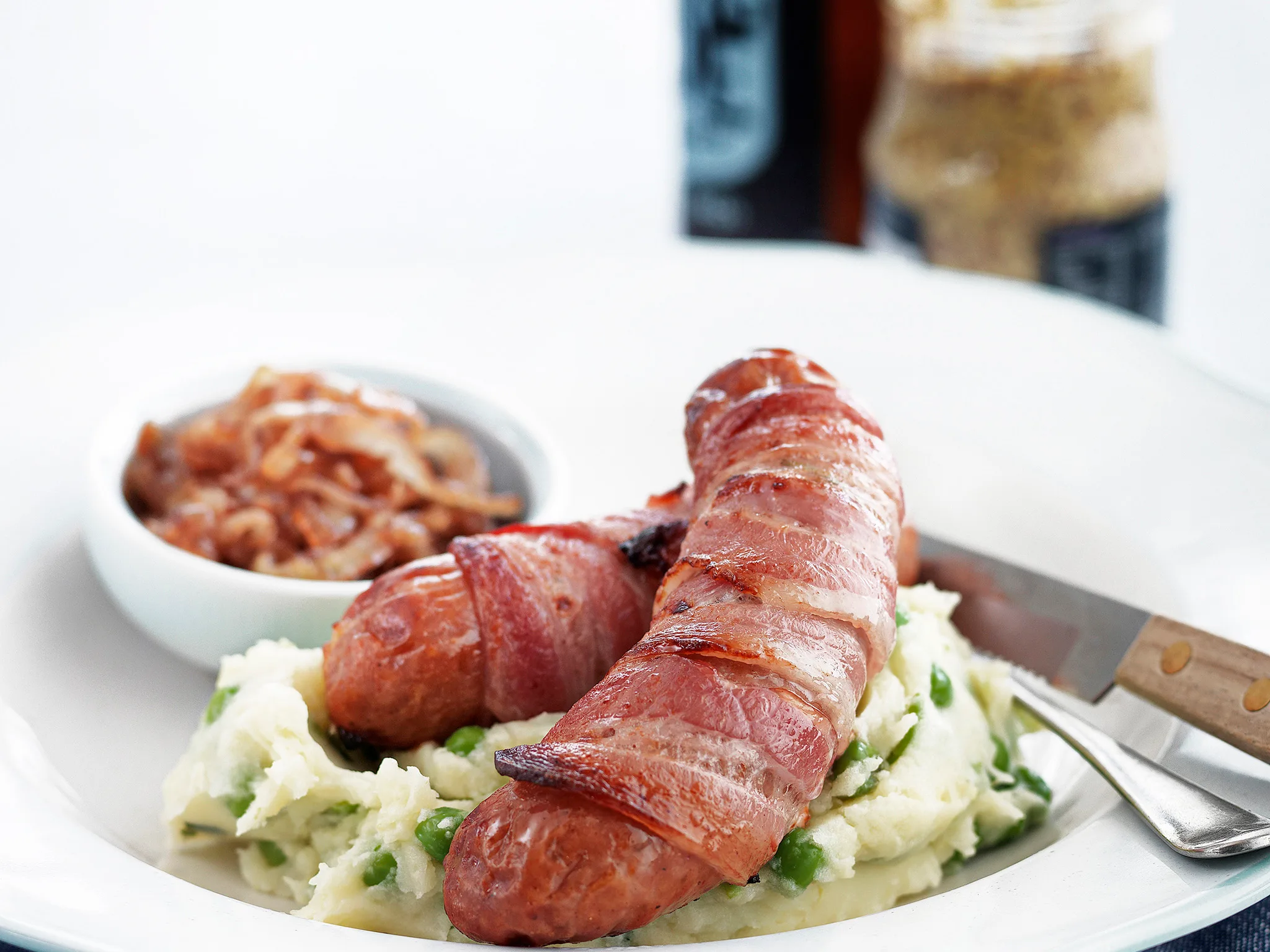 Sausage and bacon wraps with minted pea mash