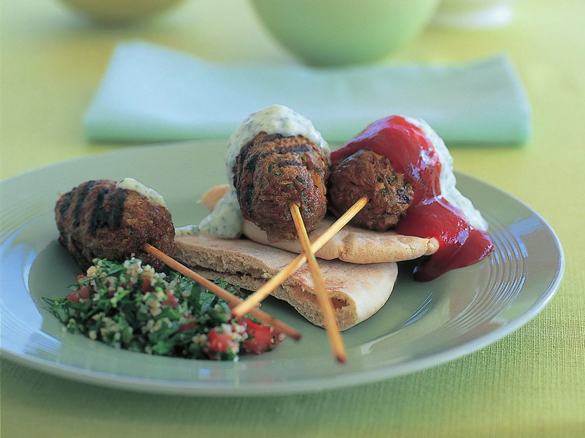 lamb kofta with chilli tomato and yogurt sauce