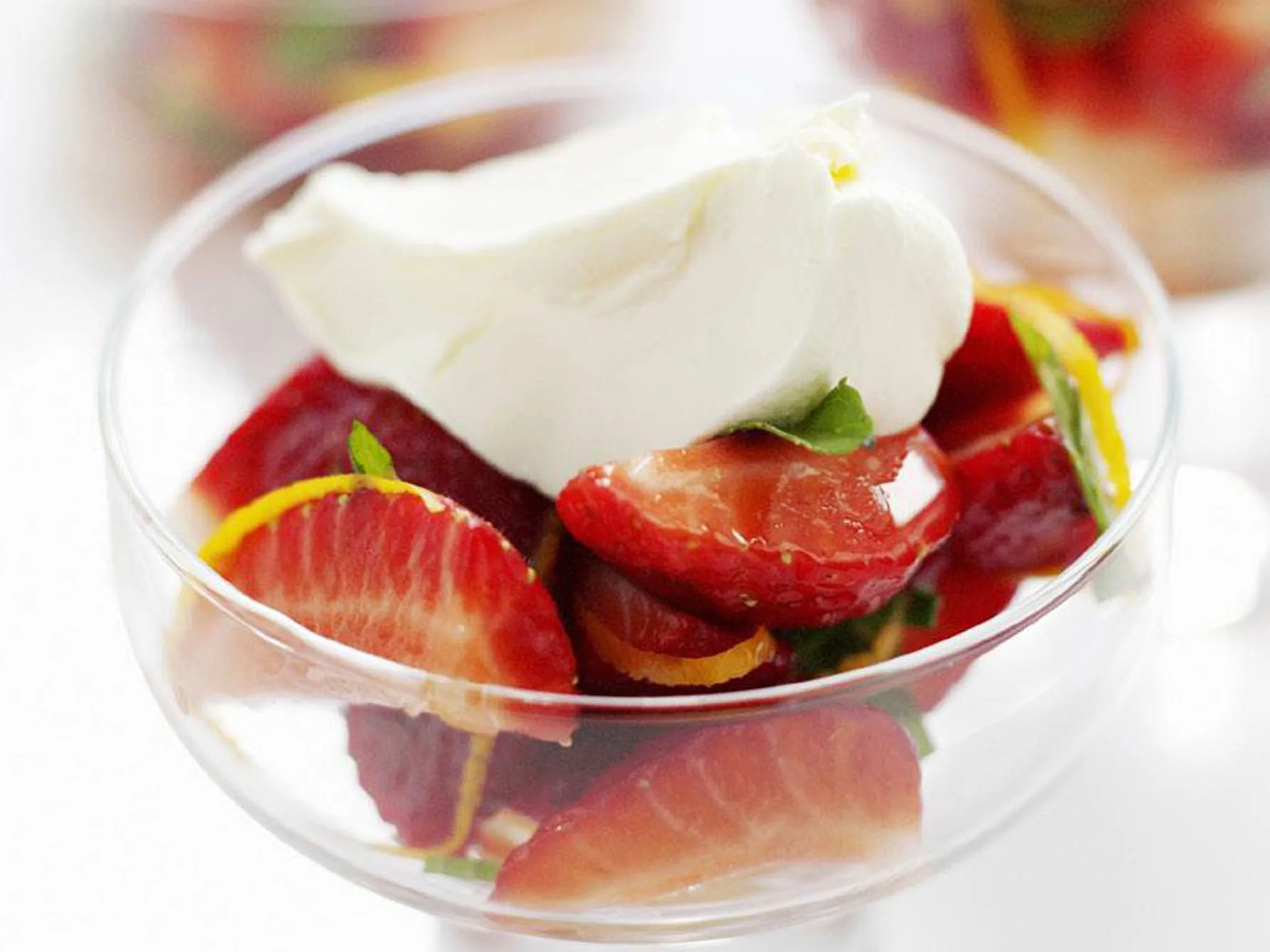 strawberries and mint in orange syrup