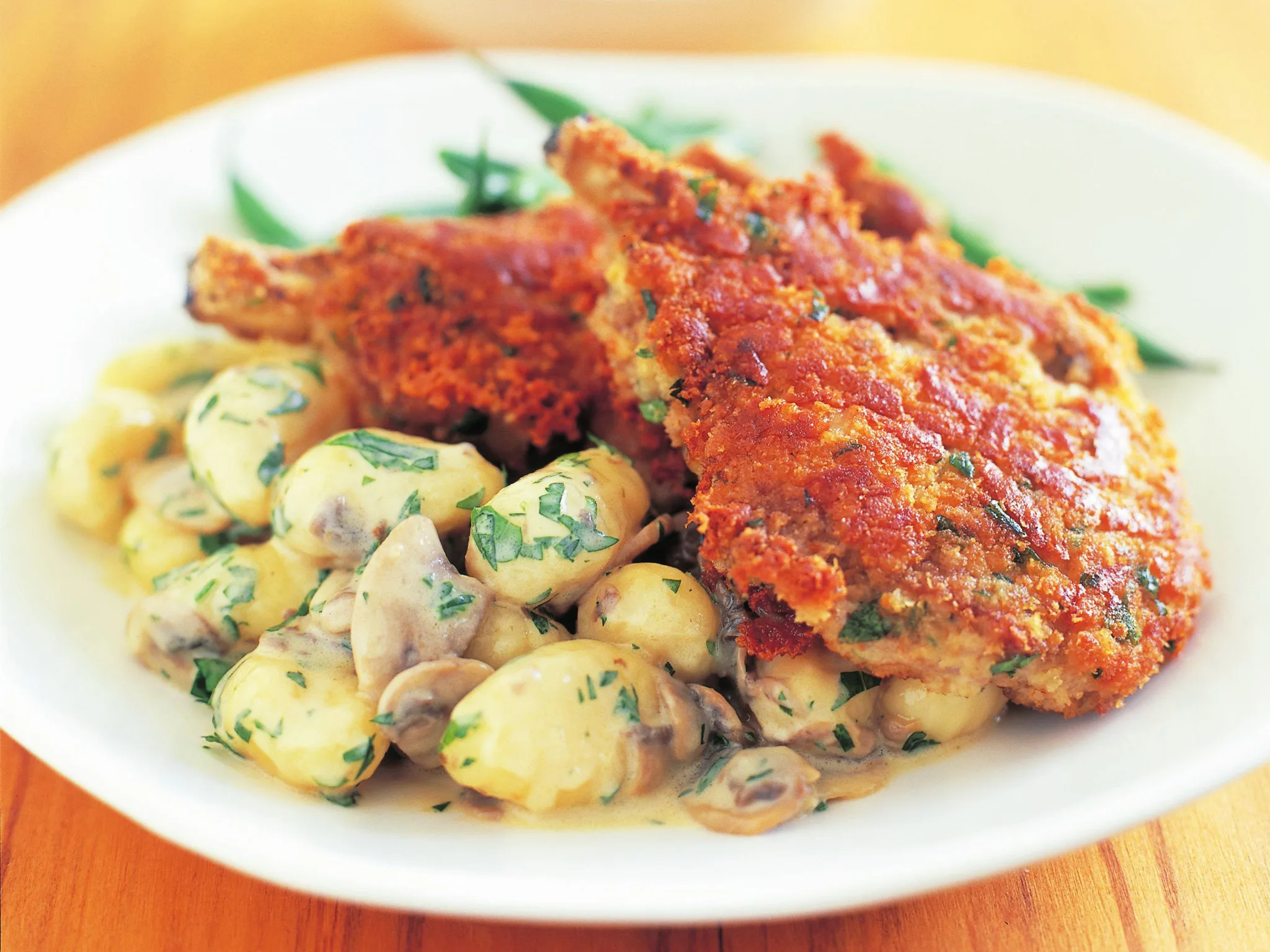 breaded veal cutlets with gnocchi in garlic mushroom sauce