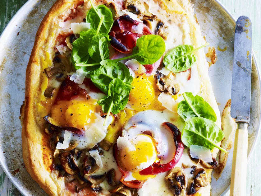 Breakfast egg, mushroom and prosciutto pizzas