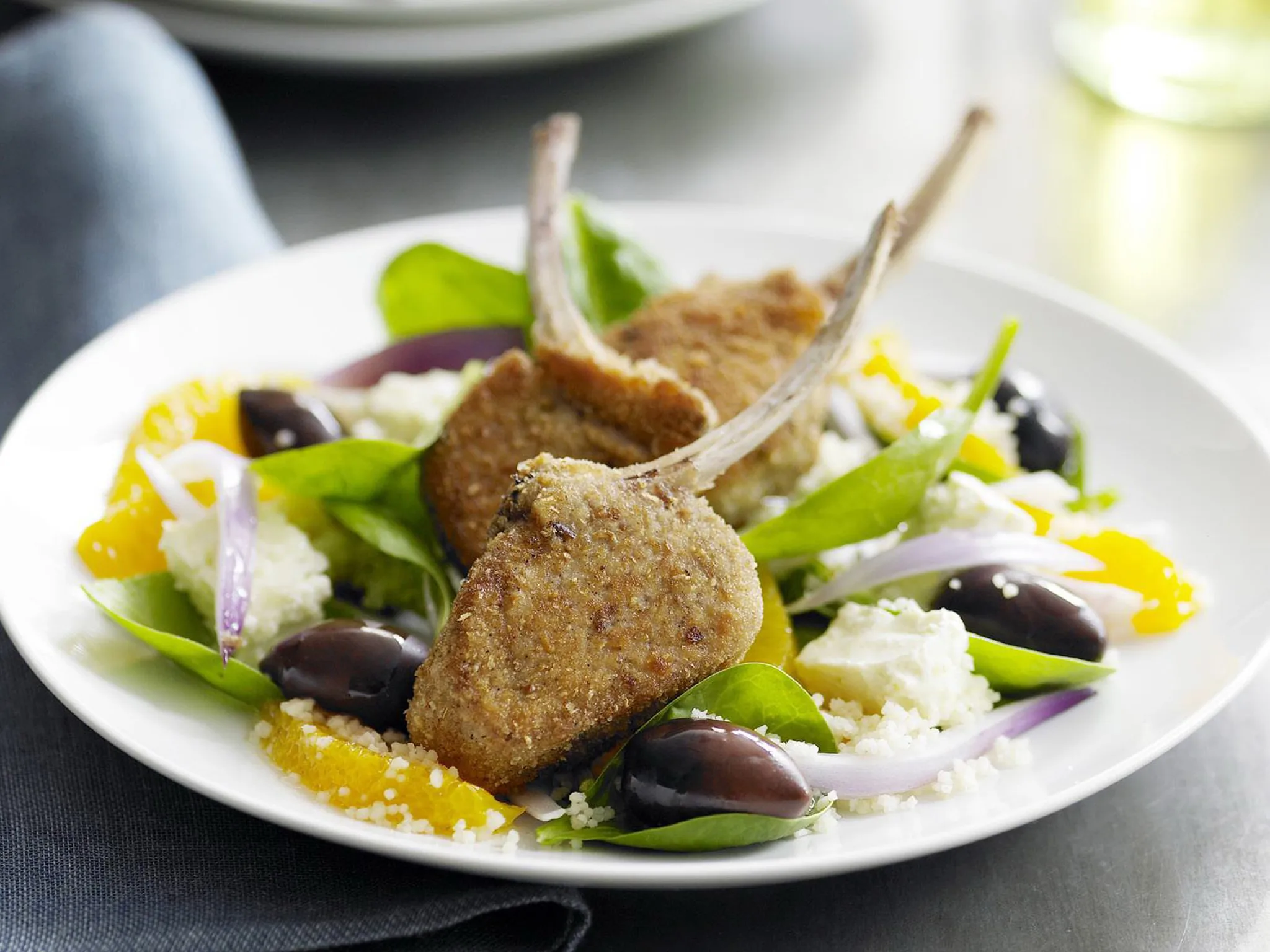Crumbed lamb cutlets with orange, couscous and spinach salad