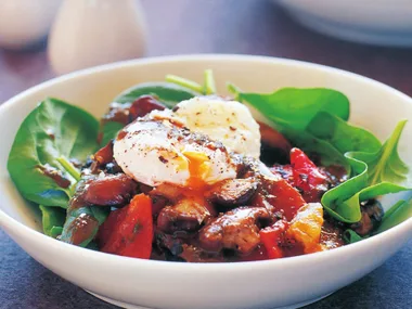 spinach salad with mushrooms, poached egg and anchovy dressing