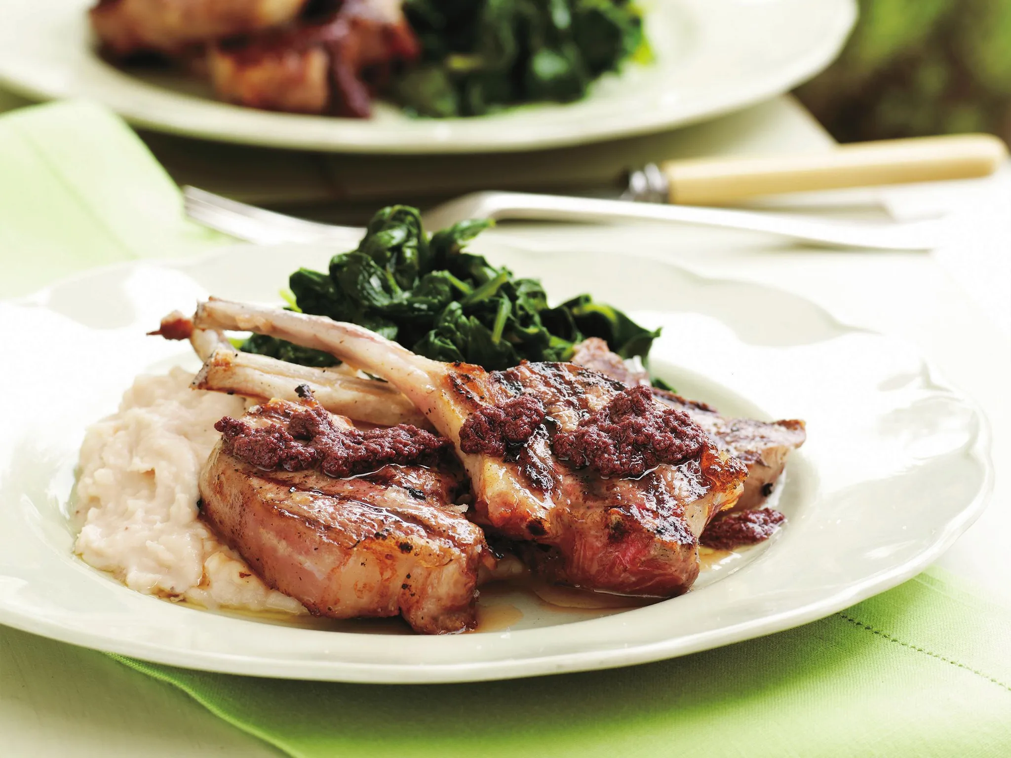 Char-grilled lamb cutlets with white bean puree and tapenade
