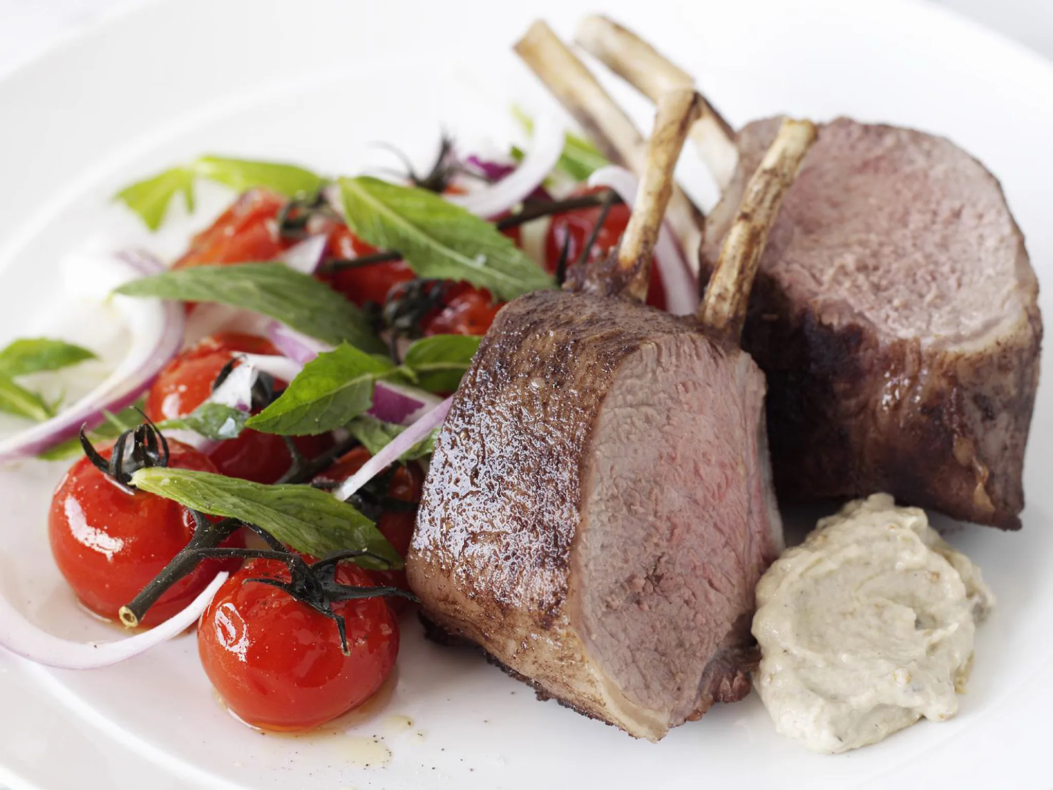 Roasted lamb racks with tomato and mint salad