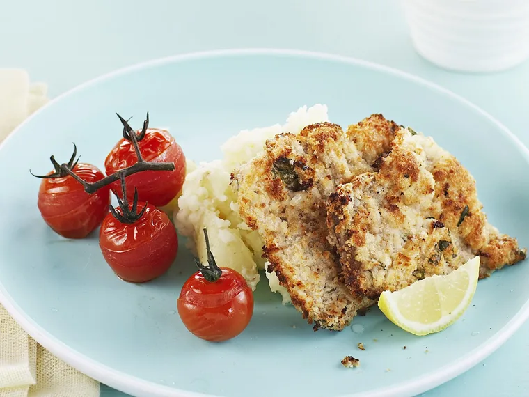 veal schnitzel, potato smash and roasted tomatoes