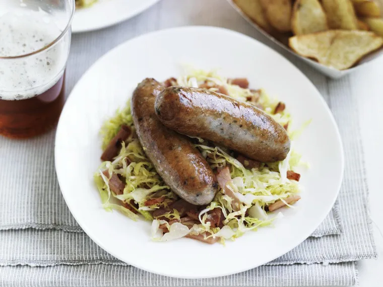 pork sausages with crispy potatoes and cabbage