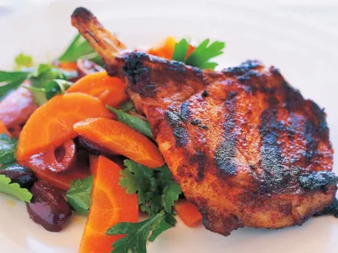Paprika and cumin-spiced pork cutlets with carrot and olive salad