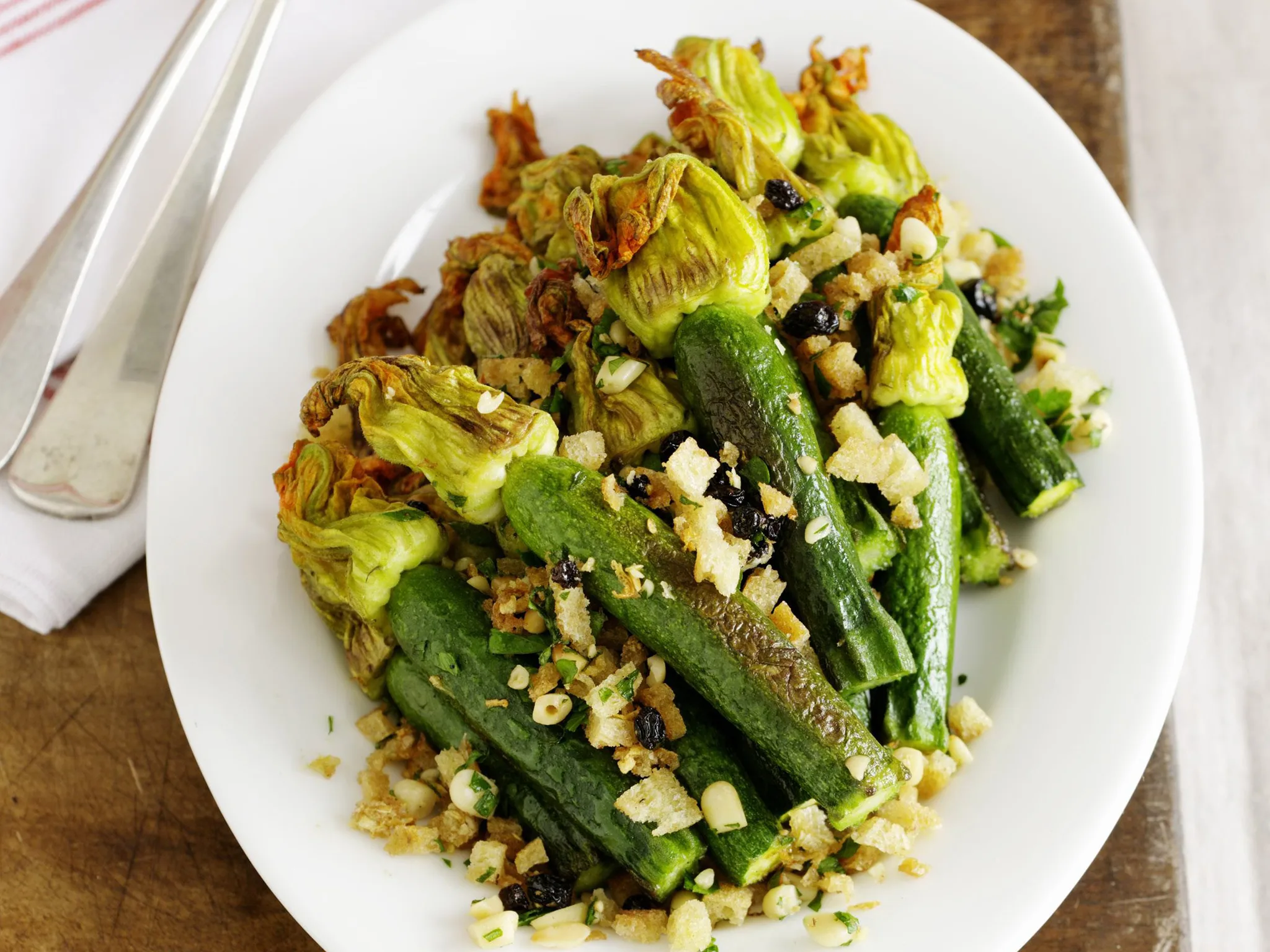 fried zucchini with pine nuts and currants