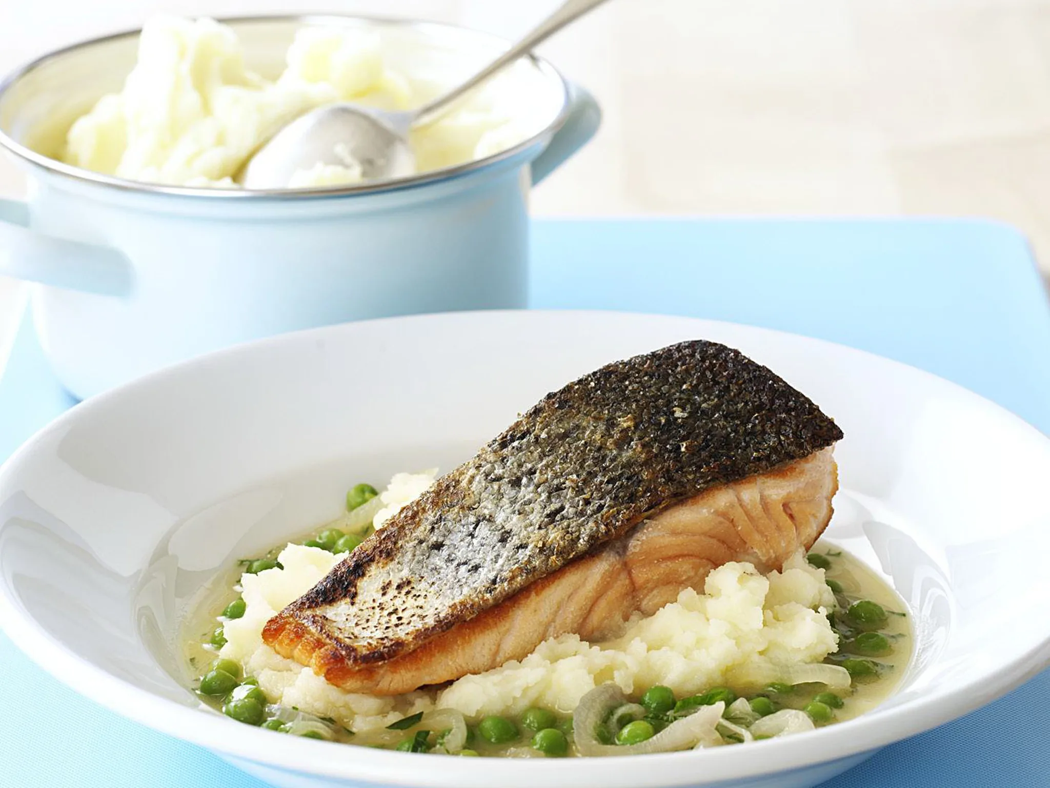 crispy-skin salmon on braised peas and mash