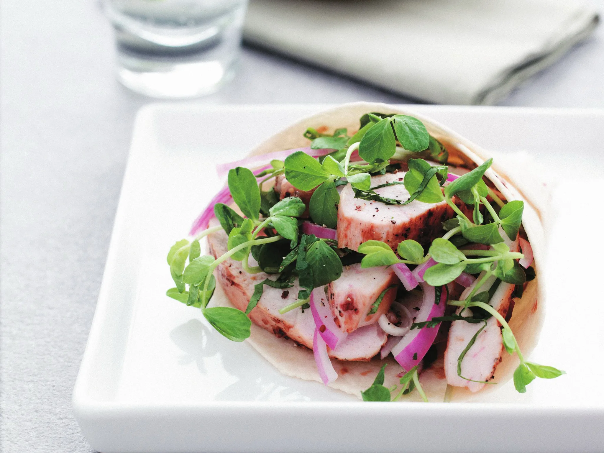 Glazed-chicken tortilla with sprout and herb salad
