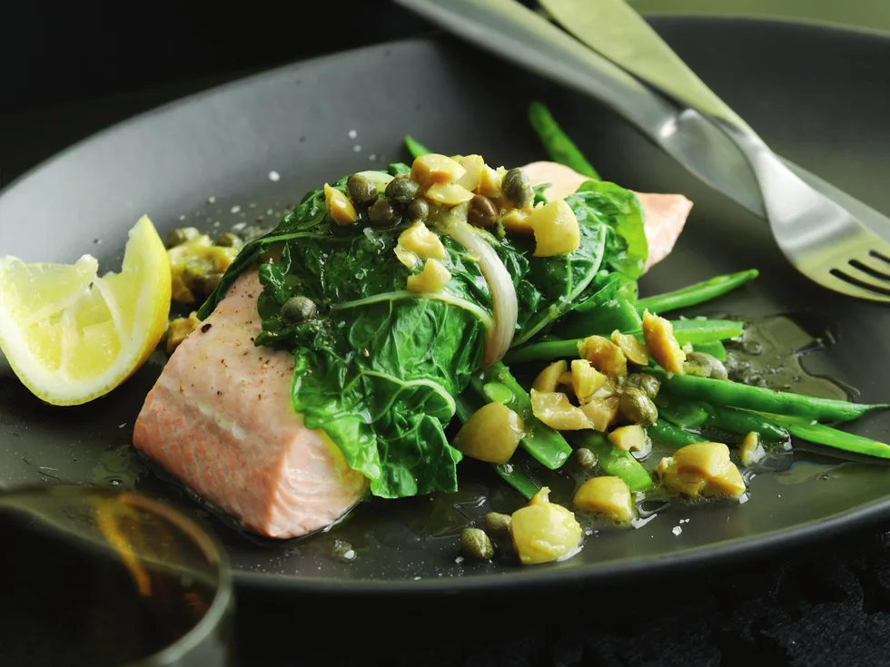 steamed salmon in spinach with lemon, olive and caper sauce