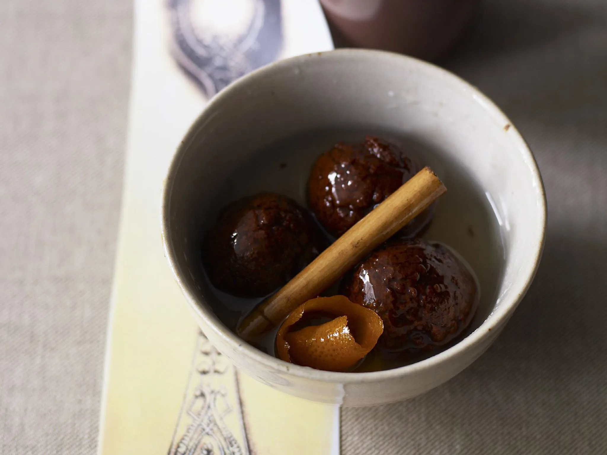 chocolate gulab jaman with orange cinnamon syrup