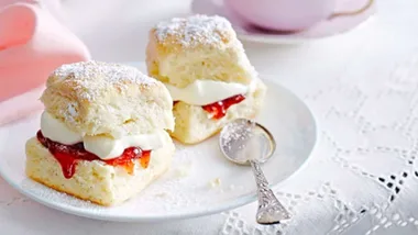 Our easy basic scone recipe, one of our favourite scone recipes, served on a plate with cream and jam