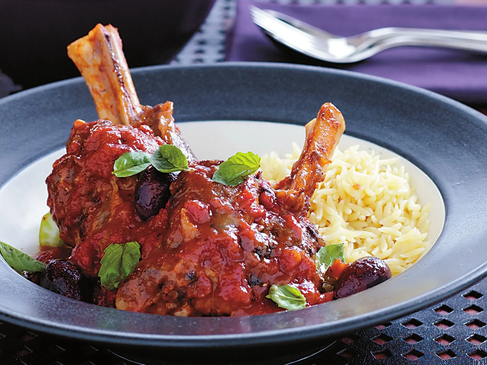 Slow-roasted lamb shanks with tomato and olives