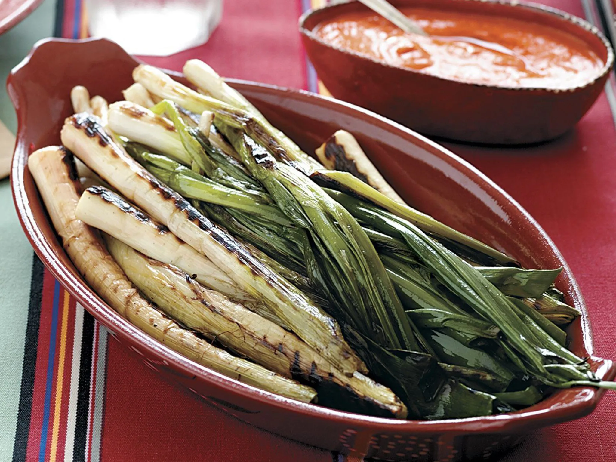 Grilled leeks and green onions with romesco sauce