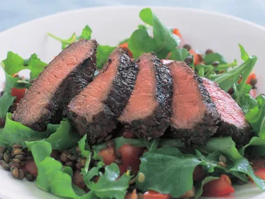 Marinated lamb backstraps with lentil and rocket salad