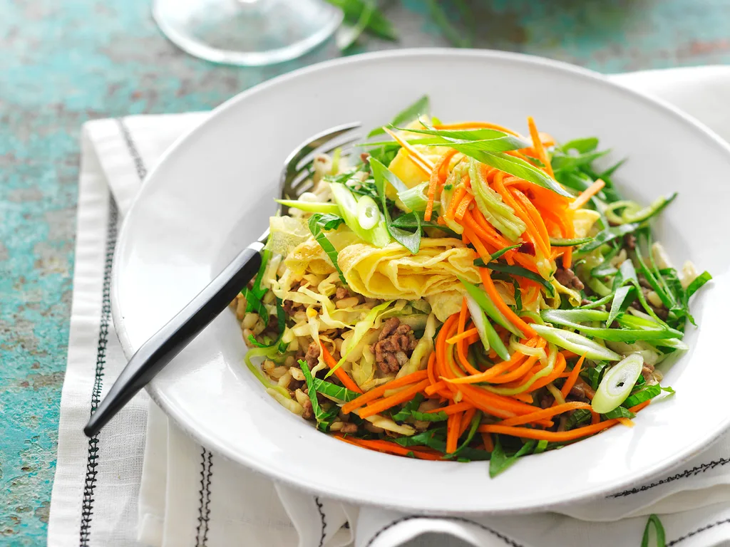 stir-fried beef and brown rice with carrot and cucumber pickle