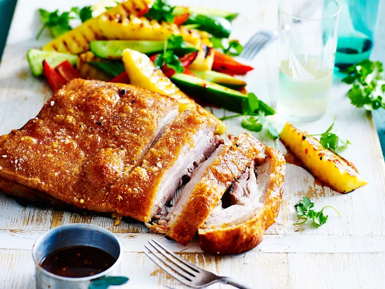 Crispy pork belly with pineapple salad on a platter