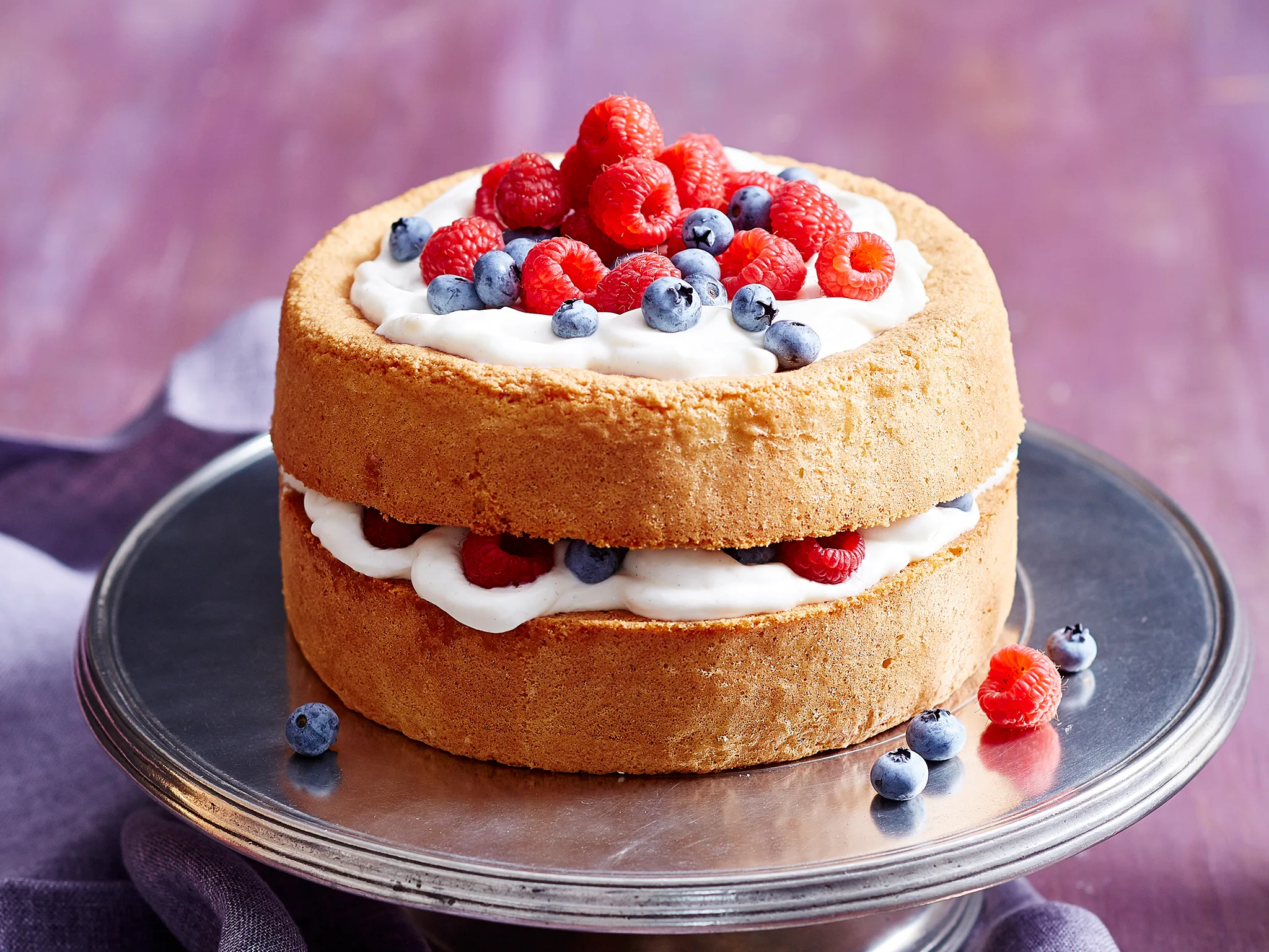 Gluten-free mixed berry and vanilla sponge layer cake-image