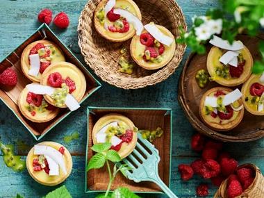 Passionfruit curd tarts with raspberries and coconut