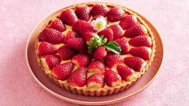 vitamin c rich strawberry tart on a pink surface