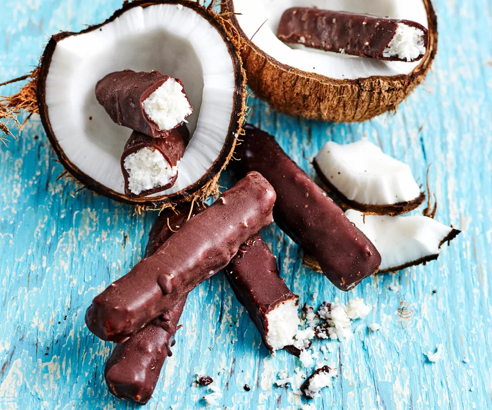 Dark chocolate bars with coconut on display with coconut shells.