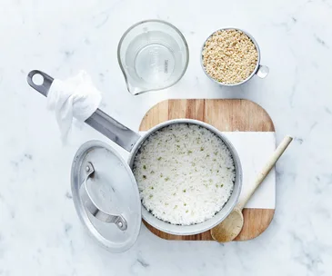 white rice being cooking in a pan