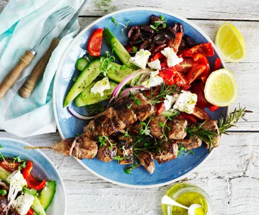 lamb kebabs with salad on a plate