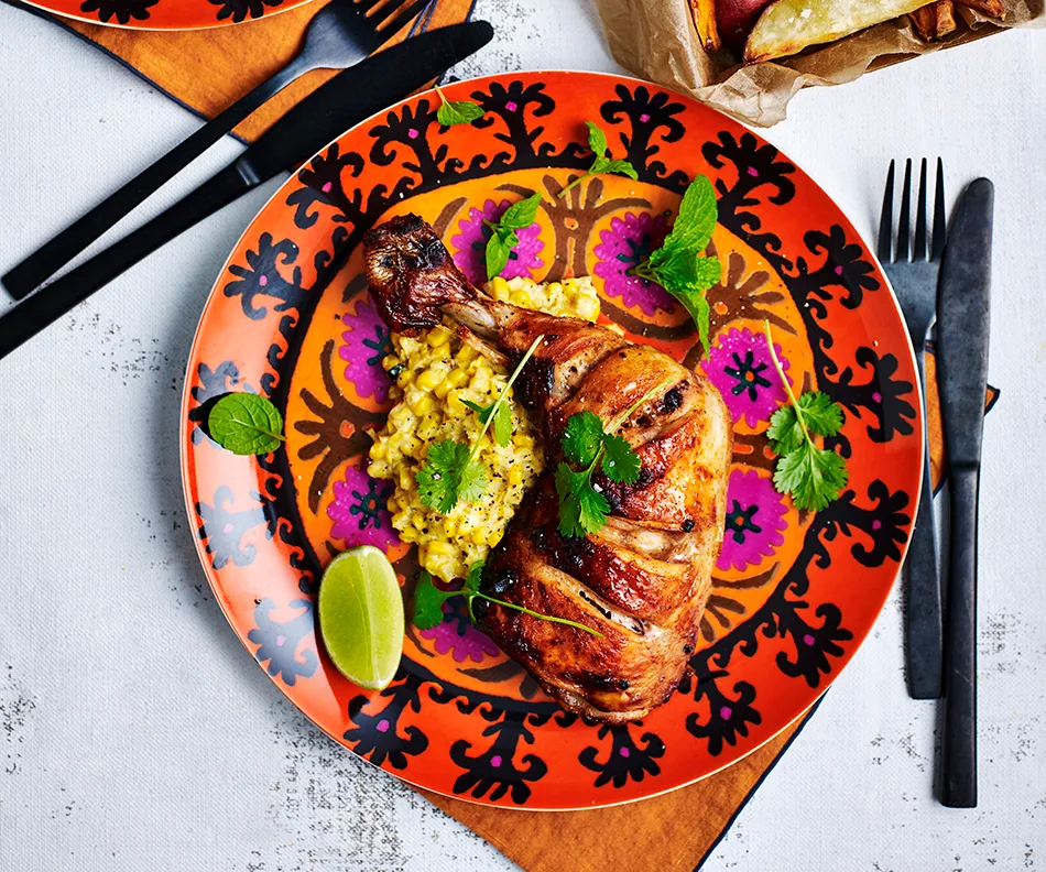 Chipotle spiced chicken pieces with creamed corn and sweet potato wedges