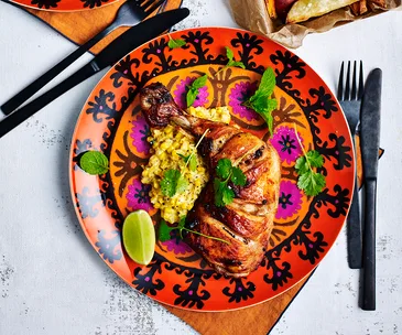 Chipotle spiced chicken pieces with creamed corn and sweet potato wedges