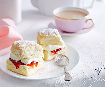 easy scone recipe on a plate with a cup of tea in the background