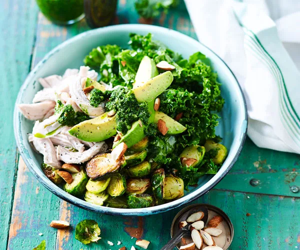 chicken, kale and avocado salad in a bowl