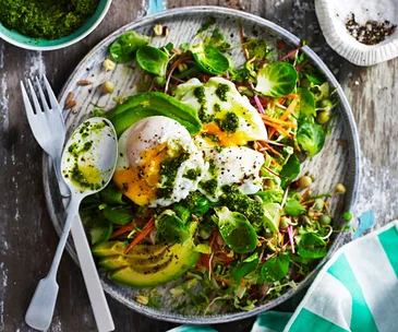 Breakfast salad with poached eggs and kale pesto