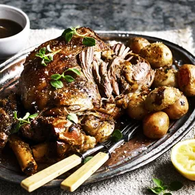 Slow-cooker lamb kleftiko on a platter with potatoes