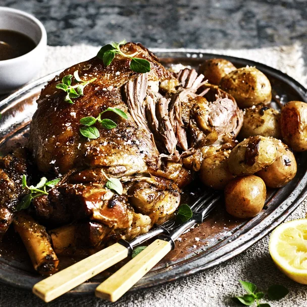 Slow-cooker lamb kleftiko on a platter with potatoes